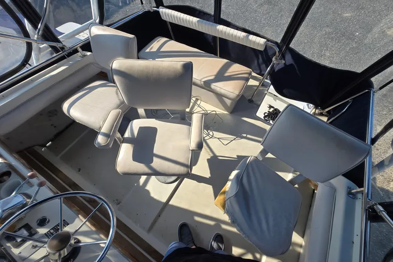 Slide: The Image of 1987 Silverton 34C boat interior with helm, seating, and steering wheel. - 13