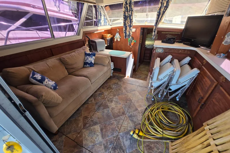 Slide: The Image of Interior of a 1987 Silverton 34C boat with sofa, TV, and nautical decor. - 21