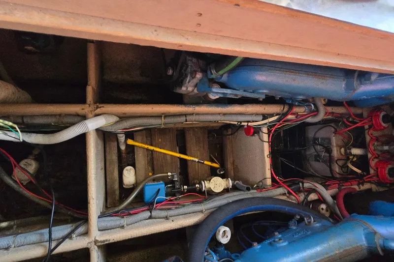 Slide: The Image of Engine compartment of a 1987 Silverton 34C boat, showing wiring and mechanical components. - 26