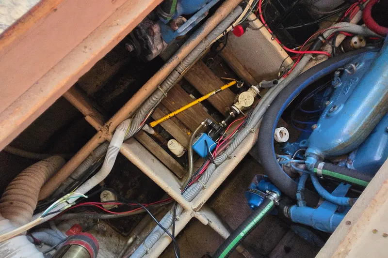 Slide: The Image of Engine compartment of a 1987 Silverton 34C boat with visible wiring and components. - 27