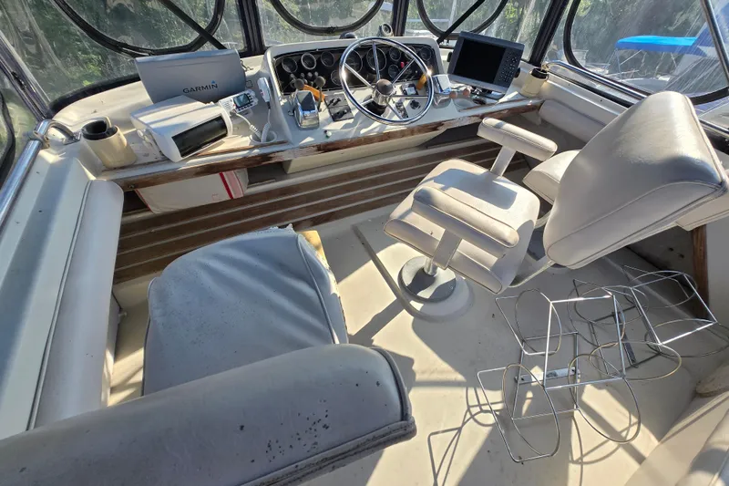 Slide: The Image of Interior of a 1987 Silverton 34C boat cockpit with steering wheel and navigation equipment. - 8