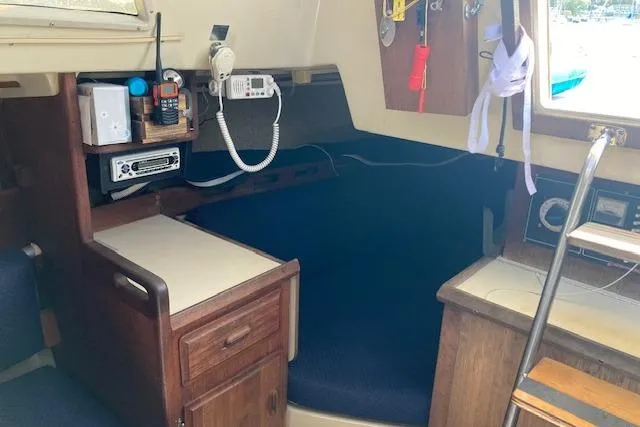 Slide: The Image of Interior of a 1985 O'Day 28 sailboat with navigation equipment and wooden cabinetry. - 13