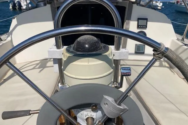 Slide: The Image of 1985 O'Day 28 sailboat cockpit with steering wheel and navigation instruments. - 16