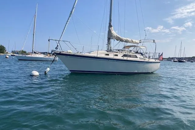 Slide: The Image of 1985 O'Day 28 sailboat anchored in a serene harbor setting. - 5