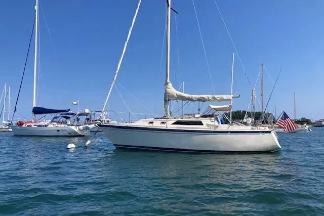 Slide: The Image of 1985 O'Day 28 sailboat anchored on a sunny day with clear blue skies. - 6