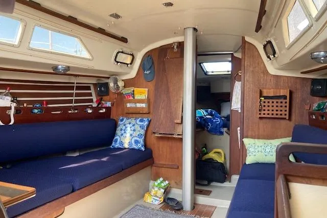 Slide: The Image of Interior of a 1985 O'Day 28 sailboat with cozy seating and nautical decor. - 7
