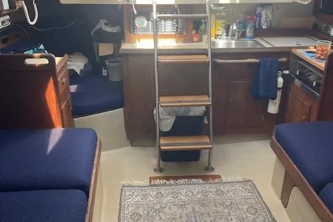 Slide: The Image of Interior of a 1985 O'Day 28 sailboat with cozy seating and compact kitchen area. - 8