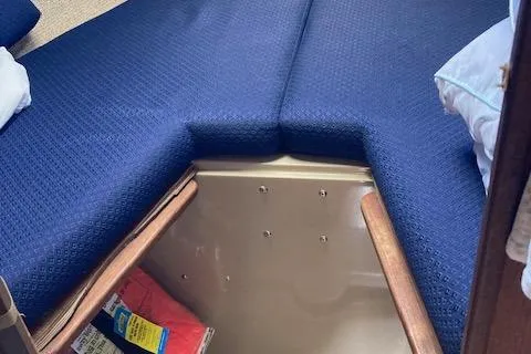 Slide: The Image of Interior cabin of a 1985 O'Day 28 sailboat with blue cushions and storage space. - 9