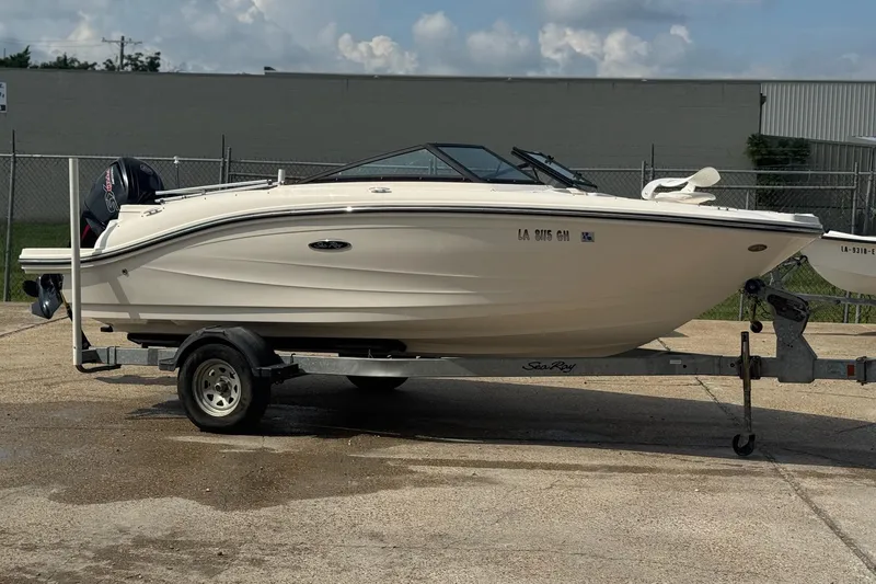 Slide: The Image of 2017 Sea Ray SPX 190 Outboard boat on trailer in marina setting. - 1