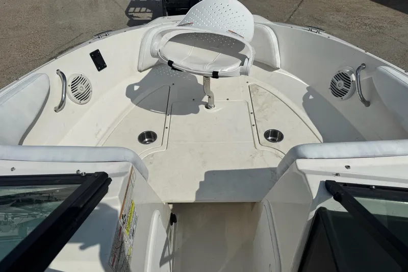 Slide: The Image of 2017 Sea Ray SPX 190 Outboard interior seating with cup holders and speaker. - 11