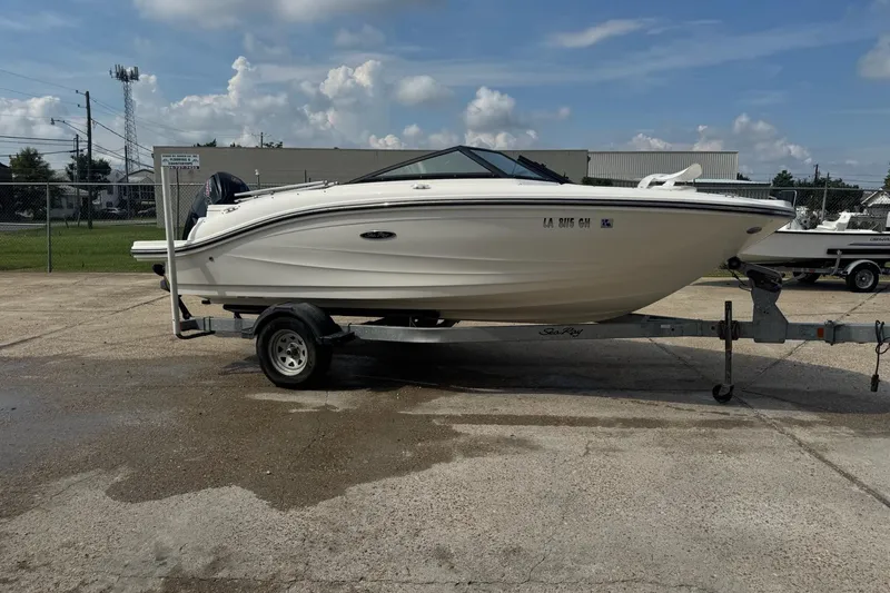 Slide: The Image of 2017 Sea Ray SPX 190 Outboard boat on trailer, parked outdoors under clear sky. - 2