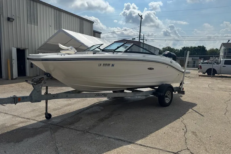 Slide: The Image of 2017 Sea Ray SPX 190 Outboard boat interior with white seating and speaker. - 9