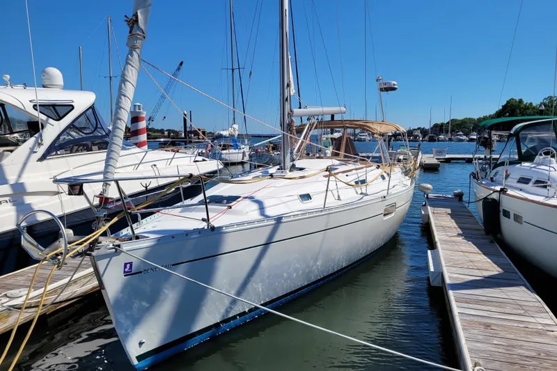 Slide: The Image of 1999 Beneteau Oceanis 351 sailboat docked at marina under clear blue sky. - 1