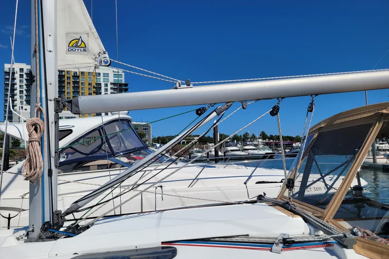 Slide: The Image of 1999 Beneteau Oceanis 351 sailboat docked at marina under clear blue sky. - 10