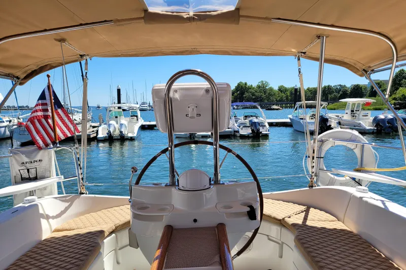 Slide: The Image of Cockpit view of a 1999 Beneteau Oceanis 351 sailboat docked at a marina. - 13