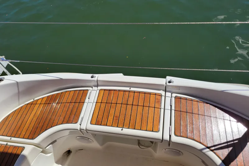 Slide: The Image of Teak deck of 1999 Beneteau Oceanis 351 sailboat, overlooking calm green water. - 19