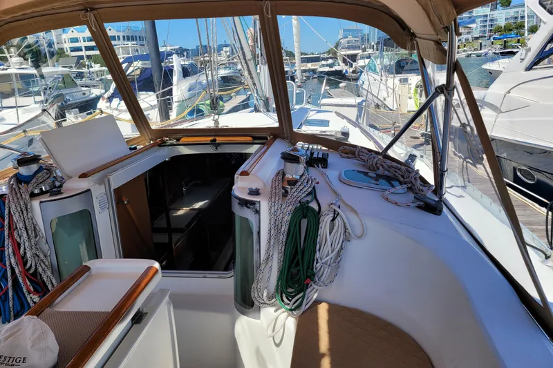 Slide: The Image of Cockpit view of 1999 Beneteau Oceanis 351 sailboat, featuring ropes and marina background. - 21
