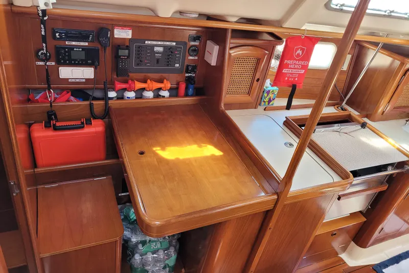 Slide: The Image of Interior of 1999 Beneteau Oceanis 351 sailboat with navigation equipment and wooden cabinetry. - 25