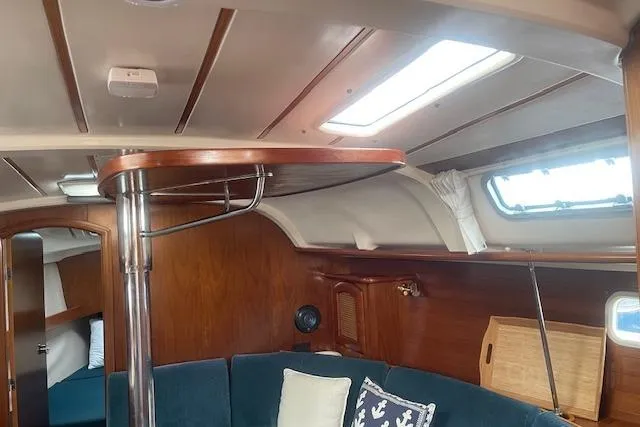 Slide: The Image of Interior of 1999 Beneteau Oceanis 352 sailboat with wooden finish and blue seating. - 29