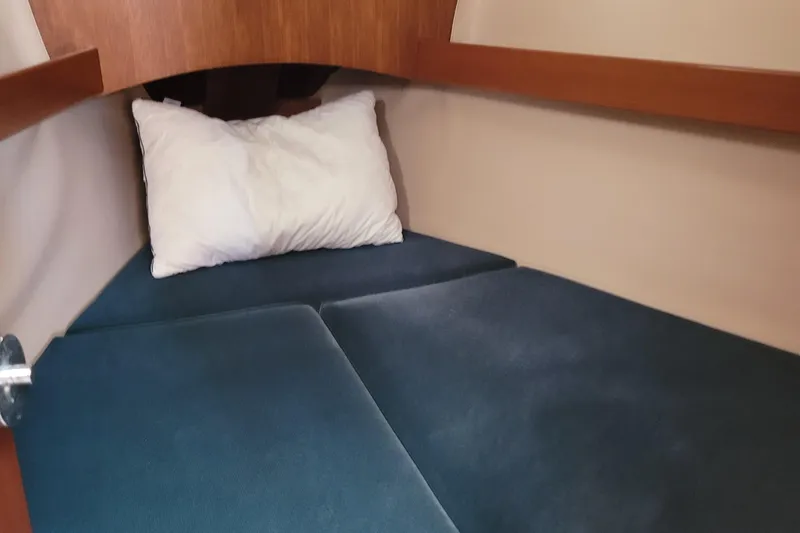 Slide: The Image of Cozy cabin interior of 1999 Beneteau Oceanis 351 sailboat with blue cushions and pillow. - 31