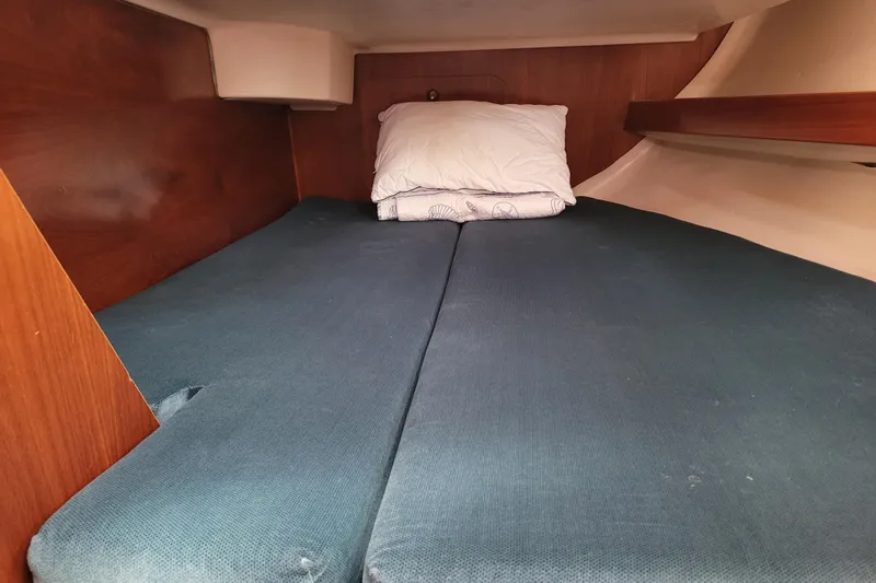 Slide: The Image of Cozy cabin interior of 1999 Beneteau Oceanis 351 sailboat with blue bedding. - 35
