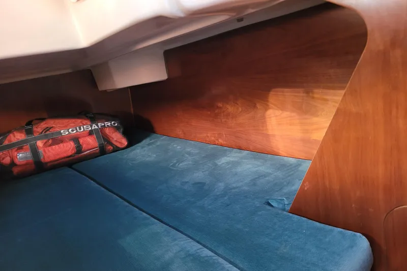 Slide: The Image of Interior cabin of 1999 Beneteau Oceanis 351 sailboat with blue cushions and scuba gear. - 39