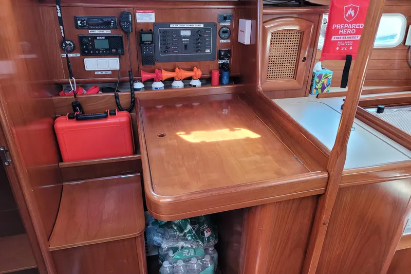 Slide: The Image of Interior of a 1999 Beneteau Oceanis 351 sailboat with navigation equipment and wooden cabinetry. - 42