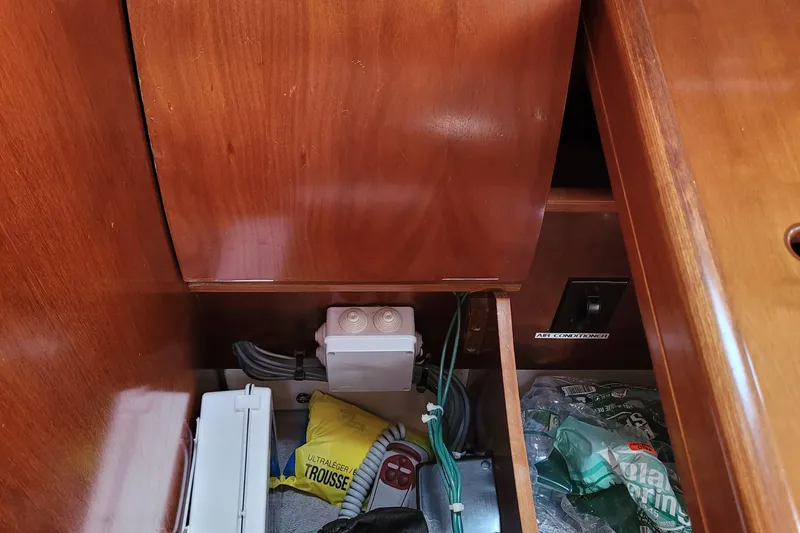 Slide: The Image of Interior storage compartment of a 1999 Beneteau Oceanis 351 sailboat with various items. - 43