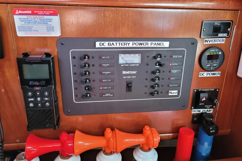 Slide: The Image of Control panel of a 1999 Beneteau Oceanis 351 sailboat with various switches and gauges. - 44