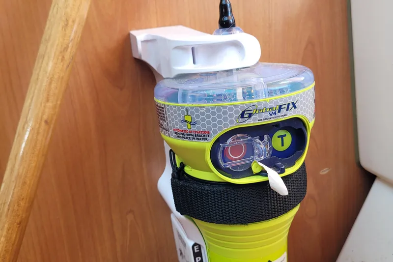 Slide: The Image of Emergency beacon on a 1999 Beneteau Oceanis 351 sailboat, mounted on a wooden panel. - 45