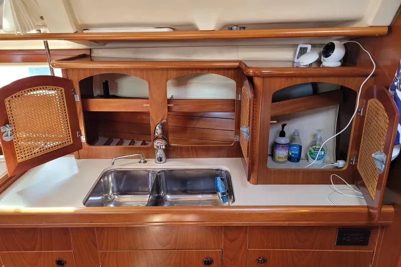 Slide: The Image of Interior of 1999 Beneteau Oceanis 351 yacht kitchen with wooden cabinets and double sink. - 47