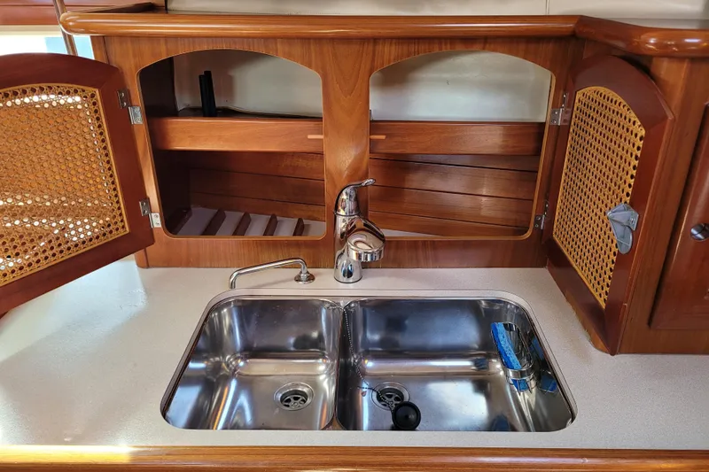 Slide: The Image of Wooden kitchen interior of 1999 Beneteau Oceanis 351 yacht with double sink and cabinets. - 49
