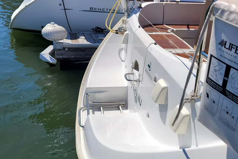Slide: The Image of Beneteau Oceanis 351 sailboat, 1999 model, docked with visible deck and ladder. - 5