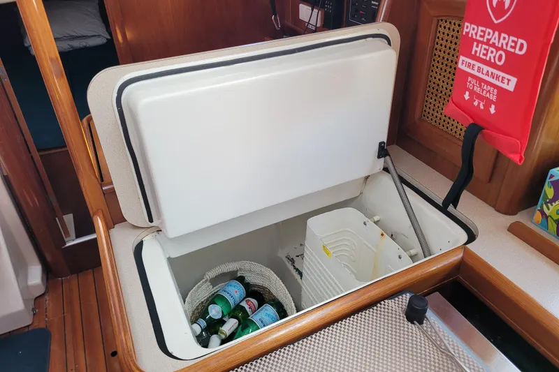 Slide: The Image of Interior of 1999 Beneteau Oceanis 351 yacht with open storage compartment and fire blanket. - 50
