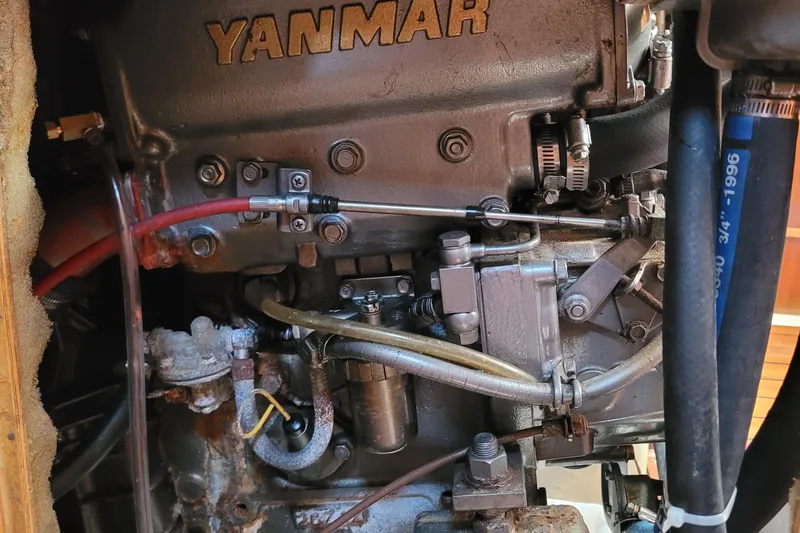 Slide: The Image of Yanmar engine in a 1999 Beneteau Oceanis 351 sailboat, showcasing mechanical components. - 52