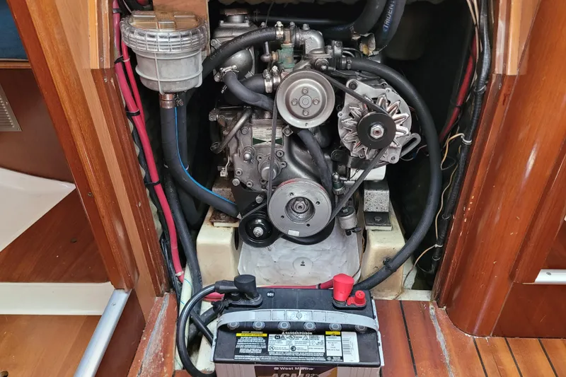 Slide: The Image of Engine compartment of a 1999 Beneteau Oceanis 351 sailboat, featuring visible battery and components. - 53