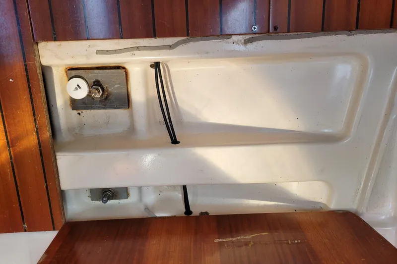 Slide: The Image of Interior view of a 1999 Beneteau Oceanis 351 sailboat, featuring wooden and fiberglass elements. - 54