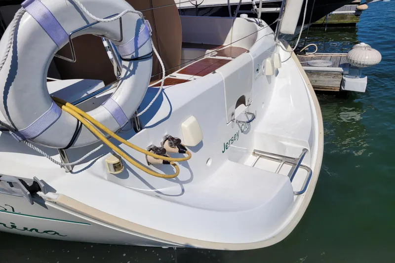 Slide: The Image of 1999 Beneteau Oceanis 351 sailboat stern with lifebuoy, docked in Jersey City marina. - 6