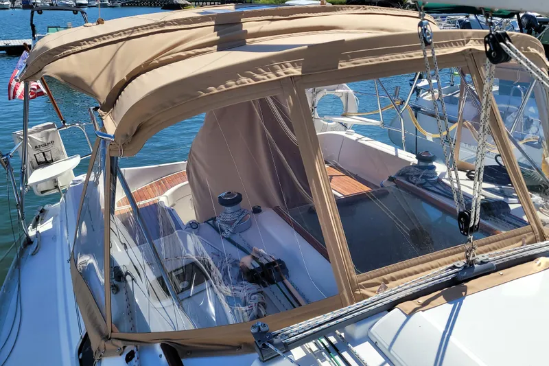 Slide: The Image of 1999 Beneteau Oceanis 351 sailboat with beige canopy docked at marina. - 8