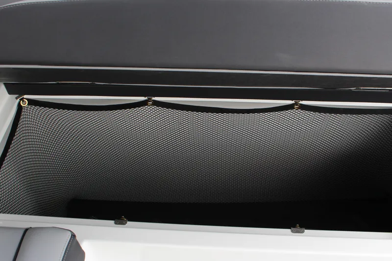 Slide: The Image of 2025 Cobalt R35 storage compartment with mesh netting for secure storage. - 11