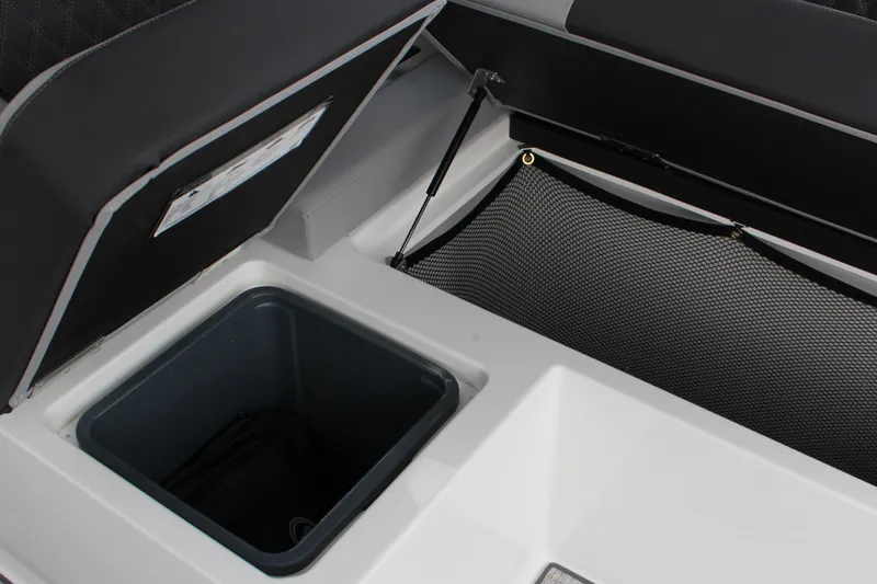 Slide: The Image of 2025 Cobalt R35 storage compartment with netting and open lid. - 12
