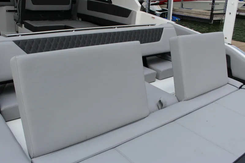 Slide: The Image of 2025 Cobalt R35 boat interior with gray cushioned seating and sleek design. - 15