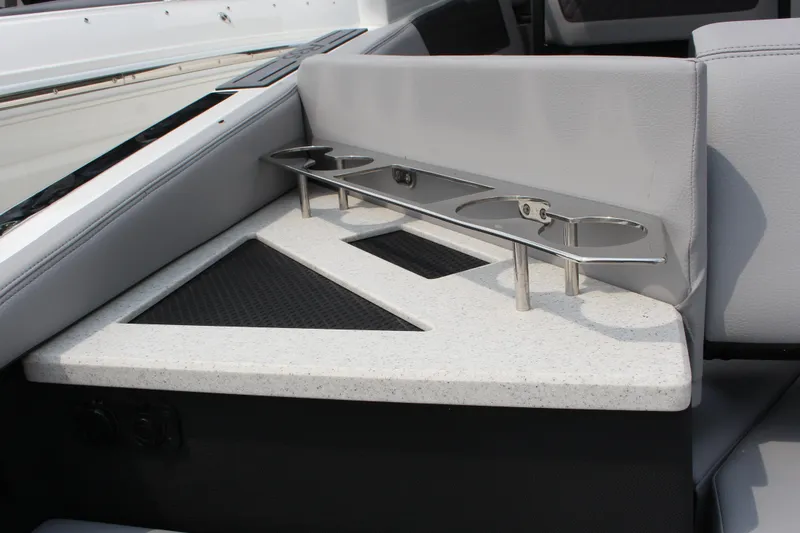 Slide: The Image of 2025 Cobalt R35 boat interior with cup holders and sleek seating design. - 16