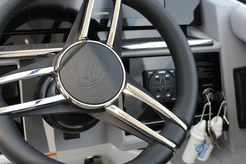 Slide: The Image of Steering wheel of 2025 Cobalt R35 boat with control panel and keys. - 18