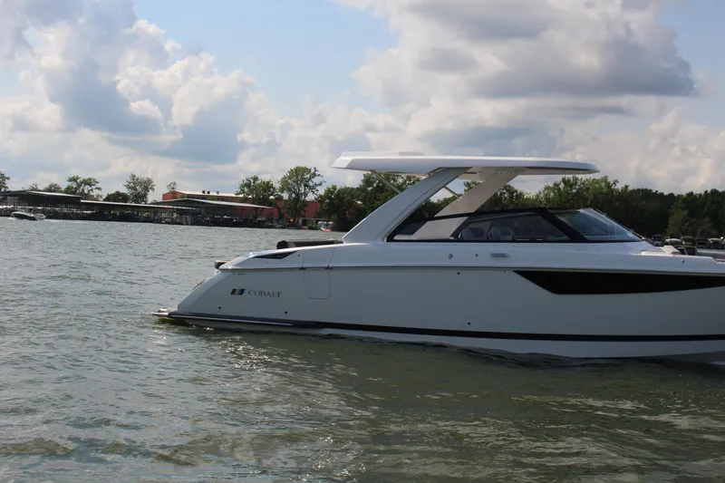 Slide: The Image of 2025 Cobalt R35 boat on a lake under a cloudy sky. - 2