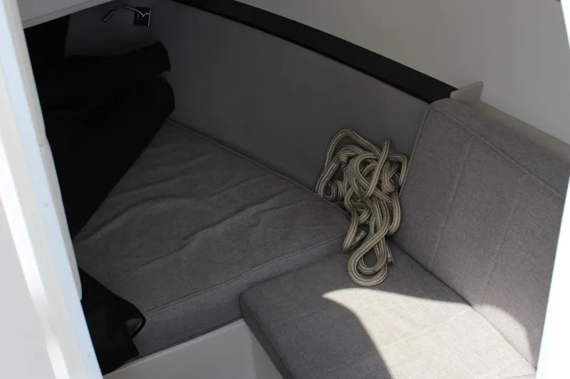 Slide: The Image of Interior cabin of 2025 Cobalt R35 boat with seating and coiled rope. - 21