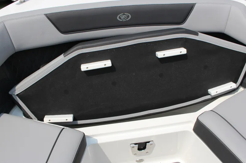 Slide: The Image of 2025 Cobalt R35 boat interior with cushioned seating and storage compartment. - 25