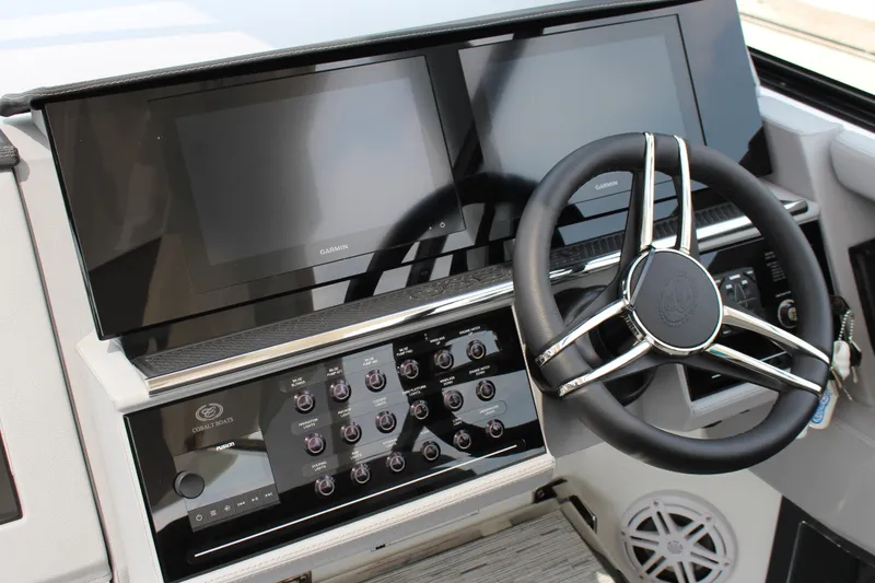 Slide: The Image of 2025 Cobalt R35 boat dashboard with dual Garmin screens and modern steering wheel. - 3
