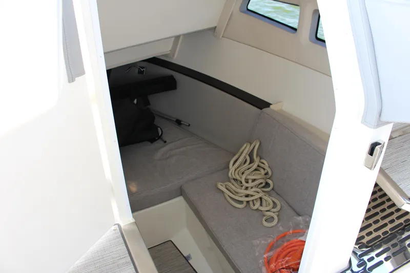 Slide: The Image of Interior cabin of 2025 Cobalt R35 boat with seating and coiled rope. - 44
