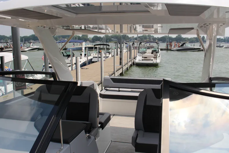Slide: The Image of Interior view of a 2025 Cobalt R35 boat docked at a marina. - 5